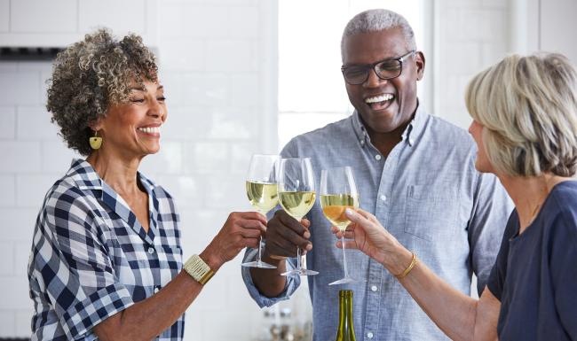 a few people toasting wine glasses